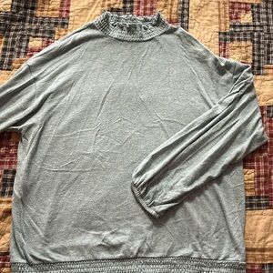 Light blue sweater with elastic waist and neck.